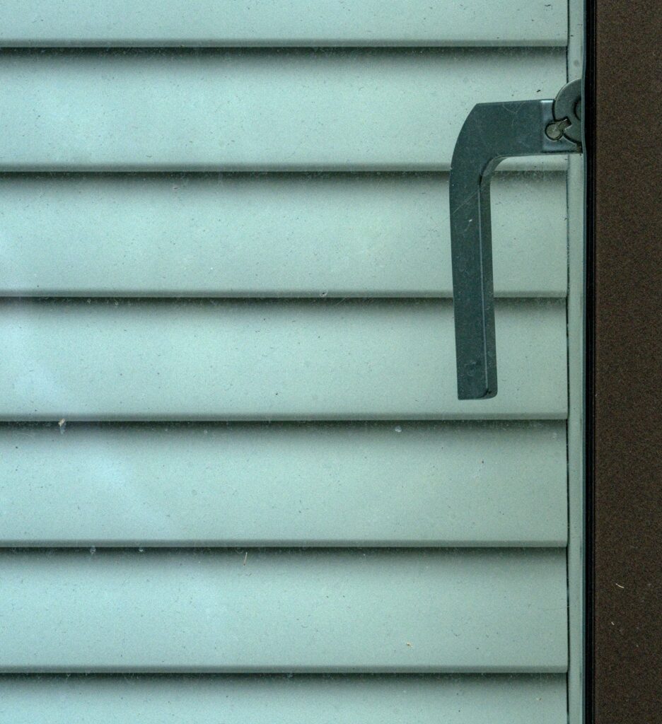 Green slatted blinds with handle